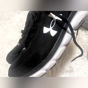 black and white unisex athletic underarmour shoes.